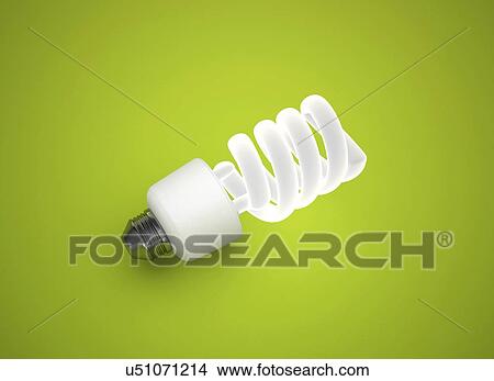 Energy saving light bulb on green background. View Large Photo Image Picture - Energy saving light bulb on green background.. Fotosearch