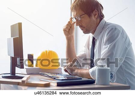 Picture - Engineer at desk.. Fotosearch