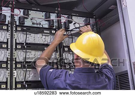 Engineer connecting energy storage batteries for backup power to an electric power plant. View Large Photo Image Stock Image - Engineer connecting energy storage batteries for backup power to an electric power plant.. Fotosearch