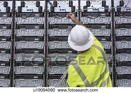Engineer connecting energy storage batteries for backup power to an electric power plant. View Large Photo Image Stock Image - Engineer connecting energy storage batteries for backup power to an electric power plant.. Fotosearch