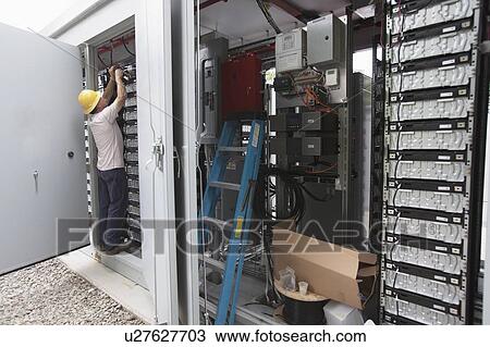 Engineer connecting energy storage batteries for backup power to an electric power plant. View Large Photo Image Stock Image - Engineer connecting energy storage batteries for backup power to an electric power plant.. Fotosearch