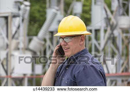 Engineer talking on cell phone at substation. View Large Photo Image Stock Image - Engineer talking on cell phone at substation.. Fotosearch