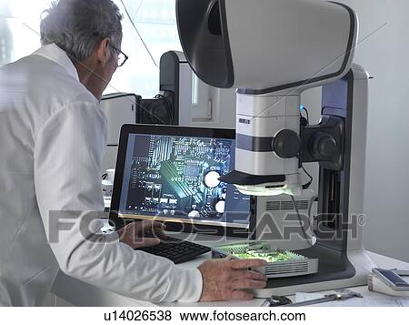 Engineer using a stereo microscope to inspect a printed circuit board during the quality control process. View Large Photo Image Stock Photo - Engineer using a stereo microscope to inspect a printed circuit board during the quality control process.. Fotosearch