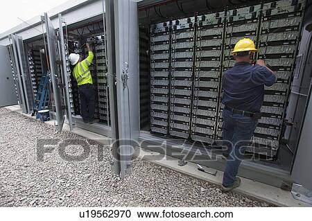 Engineers connecting energy storage batteries for backup power to an electric power plant. View Large Photo Image Stock Image - Engineers connecting energy storage batteries for backup power to an electric power plant.. Fotosearch