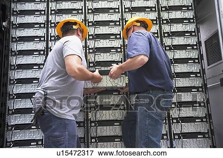 Engineers connecting energy storage batteries for backup power to an electric power plant. View Large Photo Image Stock Photo - Engineers connecting energy storage batteries for backup power to an electric power plant.. Fotosearch