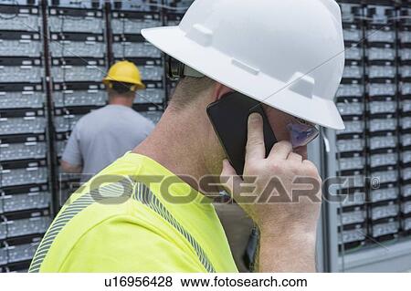 Engineers connecting energy storage batteries for backup power to an electric power plant. View Large Photo Image Stock Photo - Engineers connecting energy storage batteries for backup power to an electric power plant.. Fotosearch