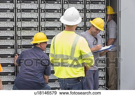 Stock Photo - Engineers connecting energy storage batteries for backup power to an electric power plant.. Fotosearch