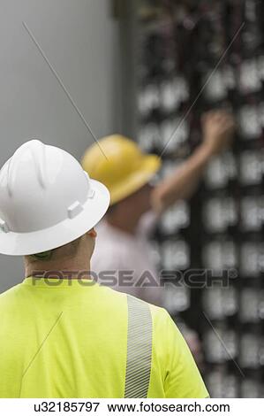 Engineers connecting energy storage batteries for backup power to an electric power plant. View Large Photo Image Stock Photo - Engineers connecting energy storage batteries for backup power to an electric power plant.. Fotosearch