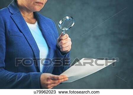 Stock Image - Examining small print, conceptual image.. Fotosearch