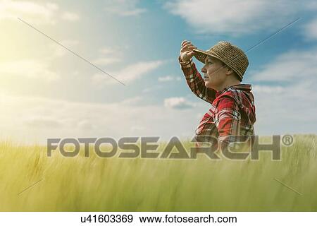Stock Photo - Farmer in wheat field.. Fotosearch