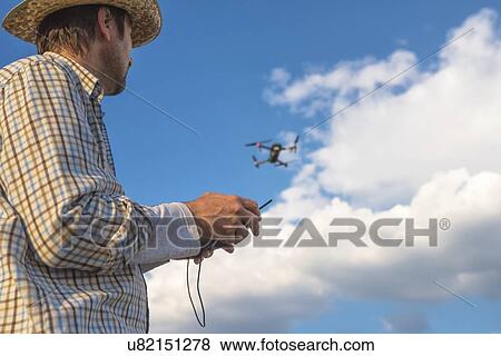Farmer piloting drone. View Large Photo Image Stock Photo - Farmer piloting drone.. Fotosearch