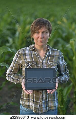 Farmer using digital tablet in field. View Large Photo Image Stock Image - Farmer using digital tablet in field.. Fotosearch