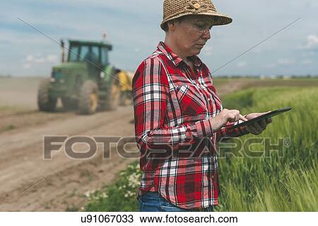 Farmer using digital tablet. View Large Photo Image Stock Image - Farmer using digital tablet.. Fotosearch