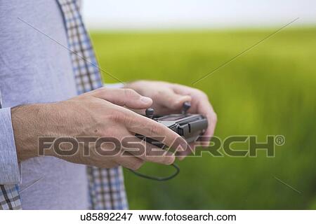 Farmer with drone control. View Large Photo Image Stock Photo - Farmer with drone control.. Fotosearch