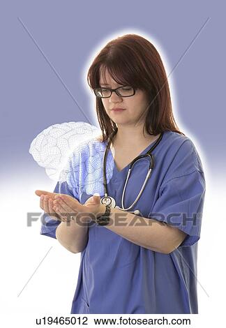 Stock Image - Female doctor holding virtual human brain.. Fotosearch