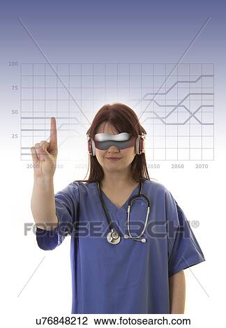 Stock Image - Female doctor wearing virtual reality headset and touching graph on virtual monitor.. Fotosearch