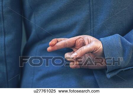 Stock Photography - Fingers crossed behind back.. Fotosearch