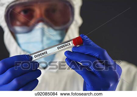Forensic scientist with evidence tube. View Large Photo Image Picture - Forensic scientist with evidence tube.. Fotosearch