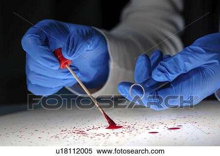 Stock Photography - Forensic technician taking bloodstain sample.. Fotosearch