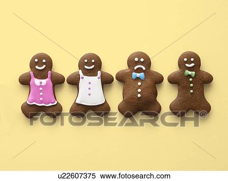 Stock Photography - Four gingerbread men and women.. Fotosearch
