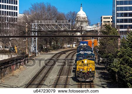 Stock Photo - Freight train with US Capitol in background approaches L'enfant Plaza Station, Washington D. C.. Fotosearch