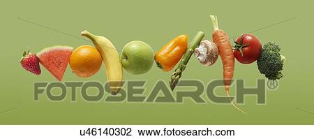 Stock Image - Fresh fruit and vegetables in a row.. Fotosearch