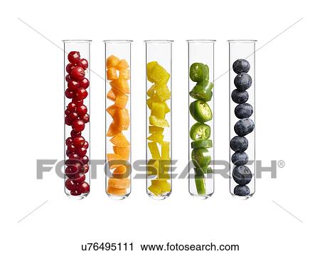 Stock Image - Fruits and vegetables in test tubes, studio shot.. Fotosearch