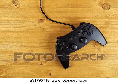 Gamepad controller on wooden desk, flat lay top view. View Large Photo Image Stock Photo - Gamepad controller on wooden desk, flat lay top view.. Fotosearch
