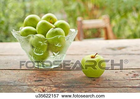 Stock Photo - Green apples on table.. Fotosearch