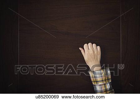 Stock Photo - Hand knocking on a door.. Fotosearch