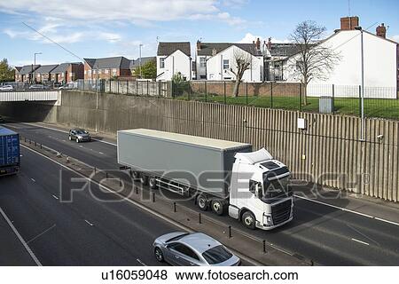 Heavy traffic on busy dual carriageway passing through a residential area. Photographed in Birkenhead, Merseyside, UK. View Large Photo Image Stock Photo - Heavy traffic on busy dual carriageway passing through a residential area. Photographed in Birkenhead, Merseyside, UK.. Fotosearch