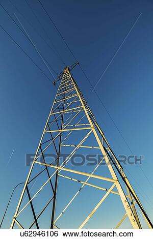 Stock Photograph - High voltage electricity pylon with wires, low angle view.. Fotosearch