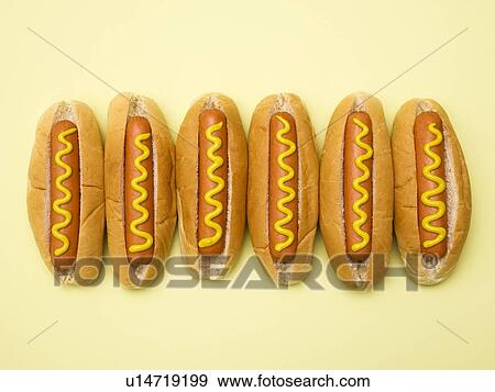 Stock Photo - Hot dogs against a plain background.. Fotosearch