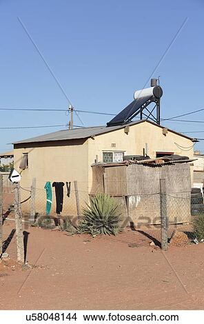 House on an informal settlement (township) with a solar water heater, Vredendal, Western Cape, South Africa. View Large Photo Image Picture - House on an informal settlement (township) with a solar water heater, Vredendal, Western Cape, South Africa.. Fotosearch