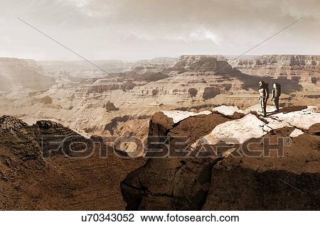 Illustration of the Valles Marineris canyon system, Mars, being surveyed by a pair of astronauts. The Valles Marineris is over 4000 kilometres (km) long, up to 200 km wide and up to 7 km deep, dwarfing the Grand Canyon of Arizona, USA. The canyons are... View Large Photo Image Stock Image - Illustration of the Valles Marineris canyon system, Mars, being surveyed by a pair of astronauts. The Valles Marineris is over 4000 kilometres (km) long, up to 200 km wide and up to 7 km deep, dwarfing the Grand Canyon of Arizona, USA. The canyons are.... Fotosearch