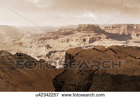 Stock Photo - Illustration of the Valles Marineris canyon system on Mars as the Sun sets. The Valles Marineris is over 4000 kilometres (km) long, up to 200 km wide and up to 7 km deep, dwarfing the Grand Canyon of Arizona, USA. The canyons are found on the.... Fotosearch