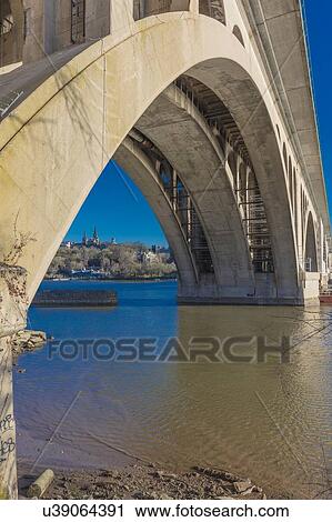 Stock Image - Key Bridge and Georgetown in background is seen on the Potomac River, Washington D. C.. Fotosearch