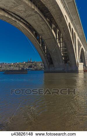 Stock Photo - Key Bridge and Georgetown in background is seen on the Potomac River, Washington D. C.. Fotosearch