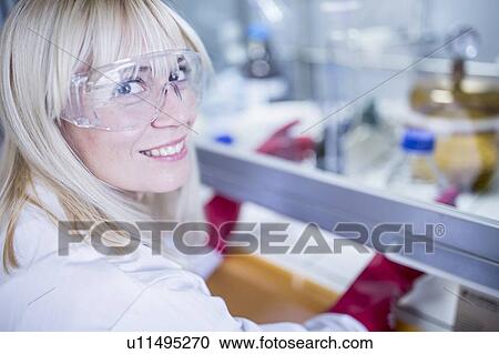 Lab technician using a laminar flow hood, thick gloves and safety goggles while working with dangerous chemicals. View Large Photo Image Stock Image - Lab technician using a laminar flow hood, thick gloves and safety goggles while working with dangerous chemicals.. Fotosearch