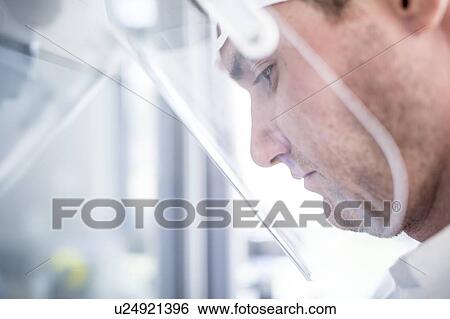 Lab technician wearing a face shield. View Large Photo Image Stock Photograph - Lab technician wearing a face shield.. Fotosearch
