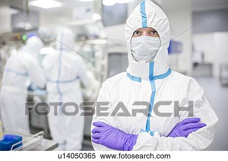 Lab technician wearing a protective suit and face mask in a laboratory that must maintain a sterile environment. View Large Photo Image Stock Photography - Lab technician wearing a protective suit and face mask in a laboratory that must maintain a sterile environment.. Fotosearch