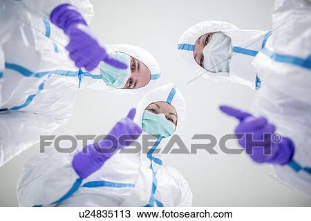 Lab technicians in a sterile environment giving the thumbs-up sign. View Large Photo Image Stock Image - Lab technicians in a sterile environment giving the thumbs-up sign.. Fotosearch