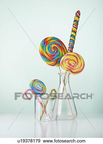 Stock Photo - Laboratory glassware with candy canes and lollipops.. Fotosearch