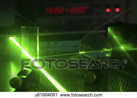 Stock Image - Laser experiment in photonics laboratory.. Fotosearch