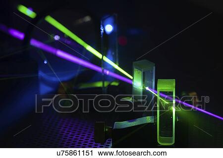Stock Image - Laser experiment in photonics laboratory.. Fotosearch