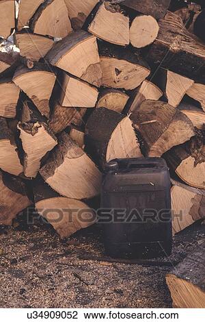 Stock Image - Logs and oil can.. Fotosearch