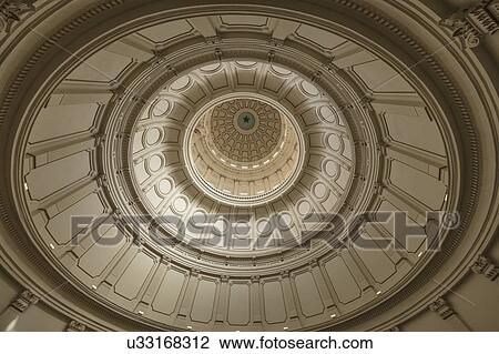 Stock Image - Looking up inside the dome of the Texas state capitol building in Austin. Fotosearch