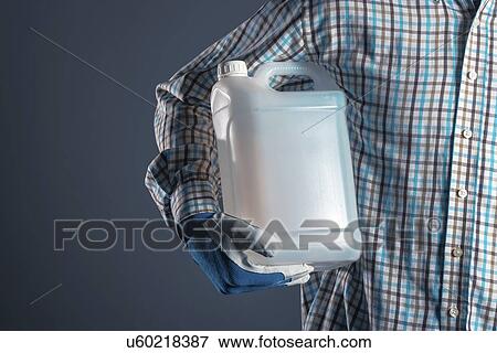 Stock Photo - Man holding plastic canister.. Fotosearch