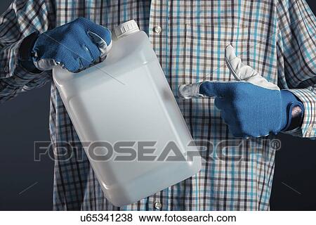 Stock Photo - Man holding plastic canister.. Fotosearch
