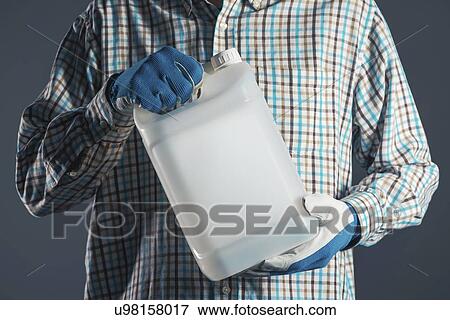 Stock Photo - Man holding plastic canister.. Fotosearch